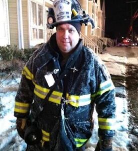 Photo of Ed Rummel in Firefighter gear.